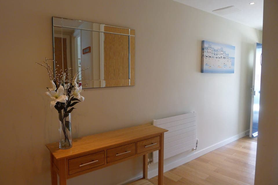 Hall with utility cupboard housing washer dryer 