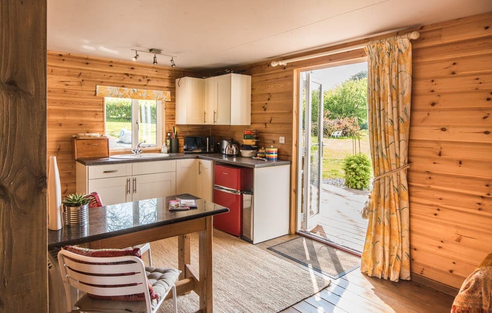 Compact but well equipped kitchen / diner with views over the gardens.