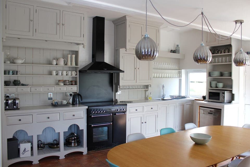 Spacious Kitchen showing large oak kitchen table that seats 10 people 