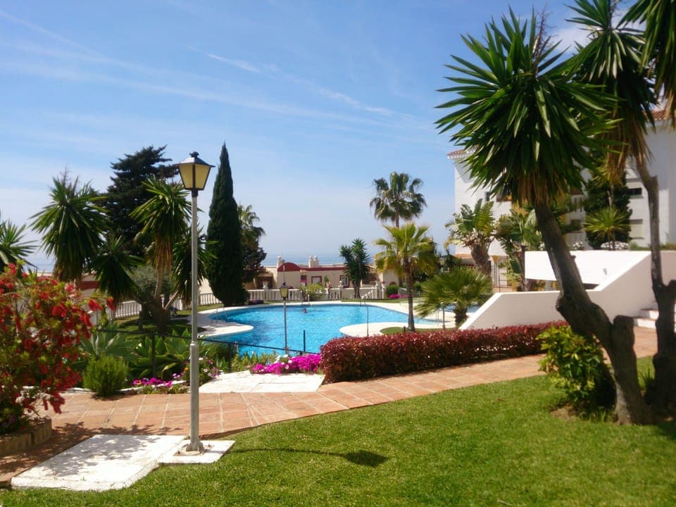 Manicured gardens pool + child pool sea beyond
