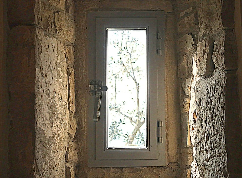 In both bedrooms there are small, medieval windows set in the old walls 