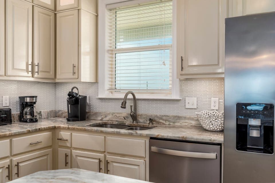 Your modern kitchen features granite countertops, stainless steel appliances, and a coffee station ready for your morning brew.