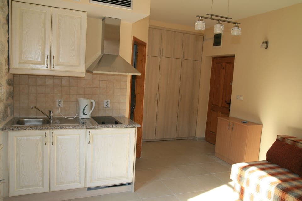 Looking from windows to kitchenette, wardrobe & front door -bathroom door centre