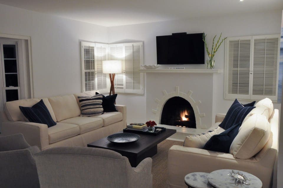 Spacious living room with two large couches and comfortable sitting chairs. 