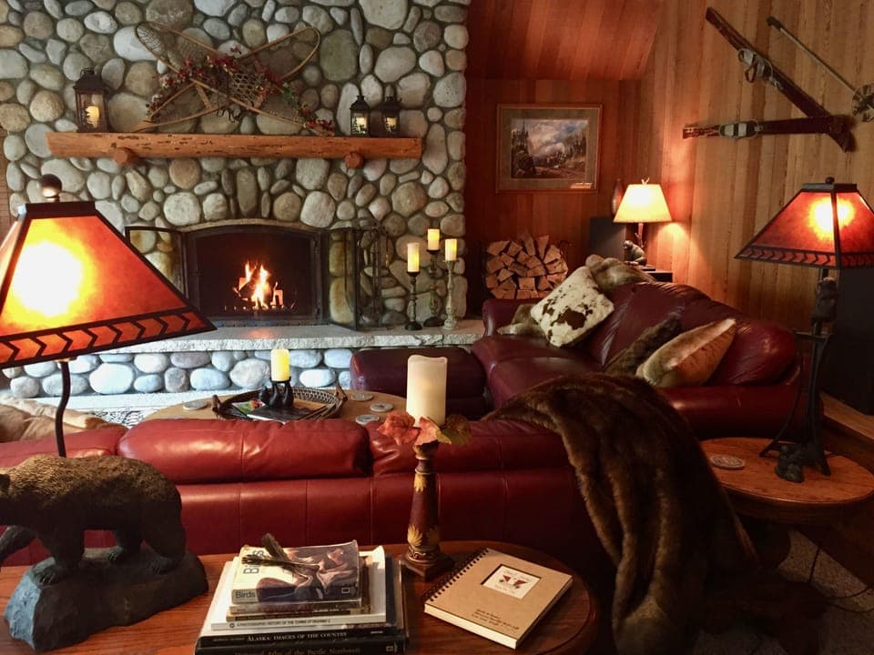 Enjoy a cozy fire in River's Edge Chalet's majestic river rock fireplace.