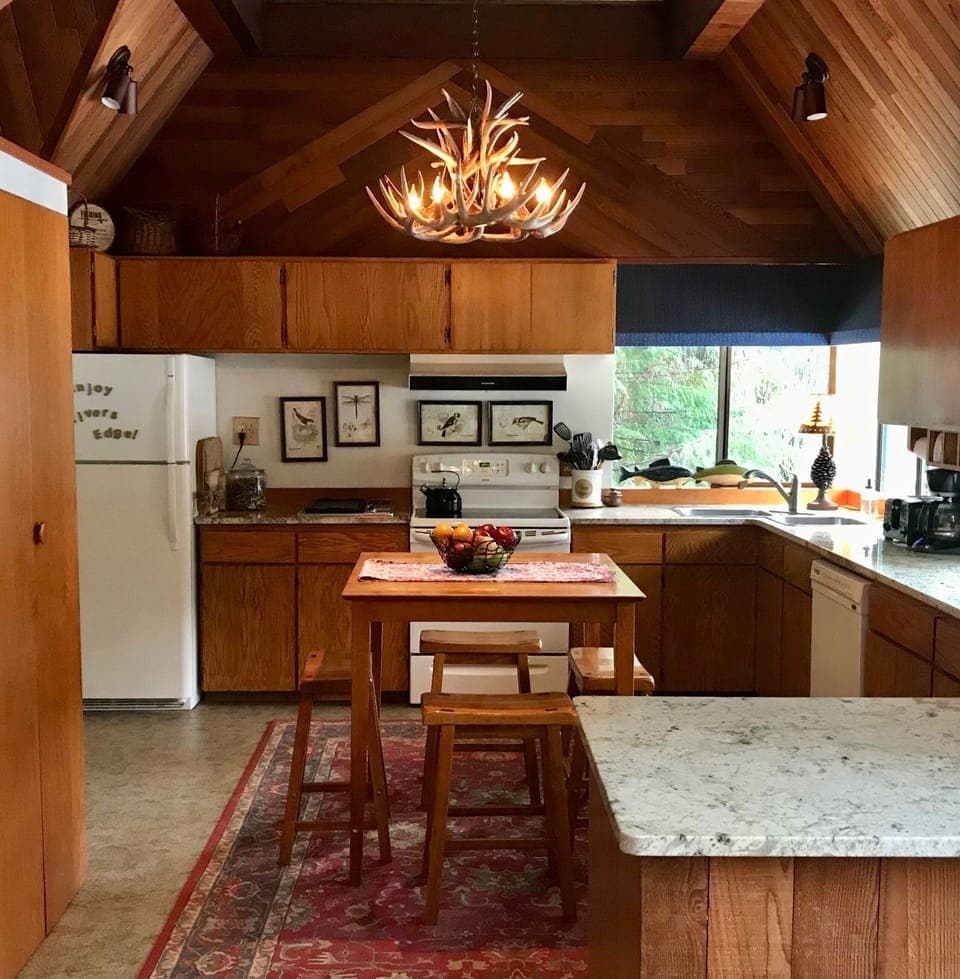 Fully equipped kitchen with soaring cedar-lined ceilings and lovely river views.