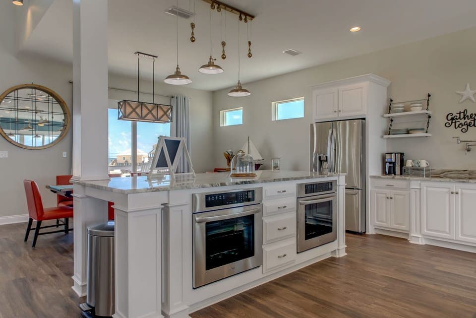 Your gourmet kitchen awaits with sleek stainless appliances, marble countertops, and stylish pendant lighting—perfect for creating memorable meals together.