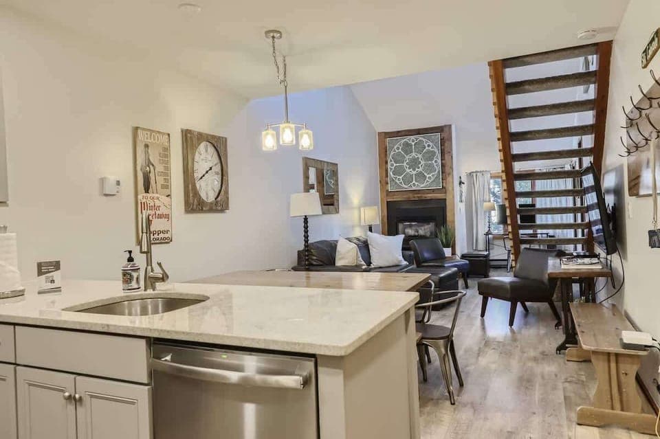 Modern Kitchen & Dining: Prepare meals in our fully equipped, modern kitchen featuring stainless steel appliances and dine in style at the spacious dining table, perfect for family meals or a cozy dinner for two.