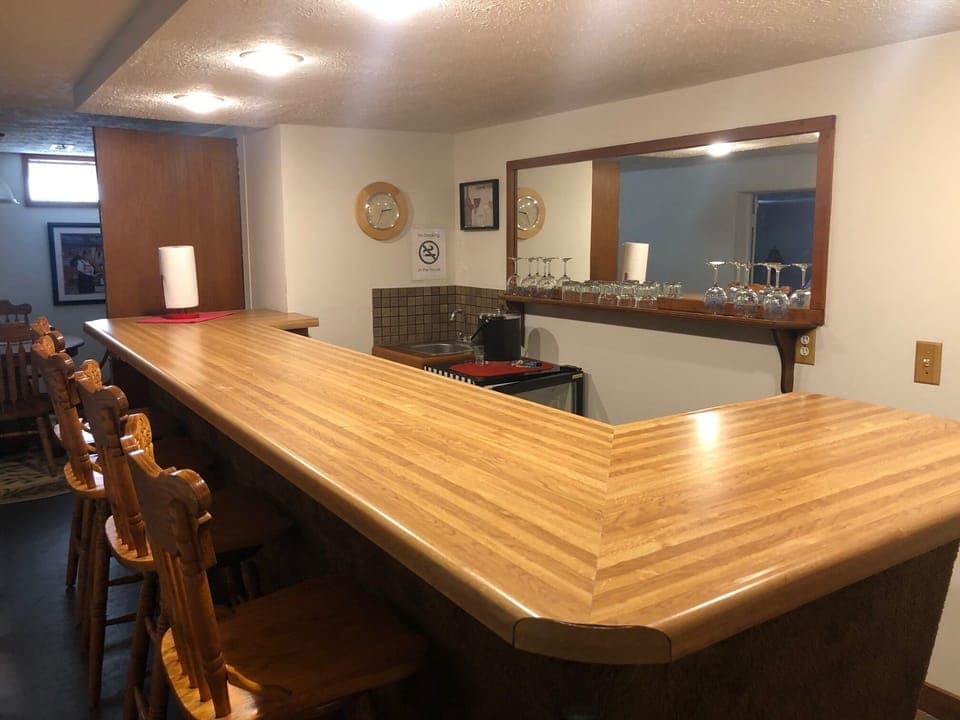Full size bar and mini refrigerator in the finished basement.
