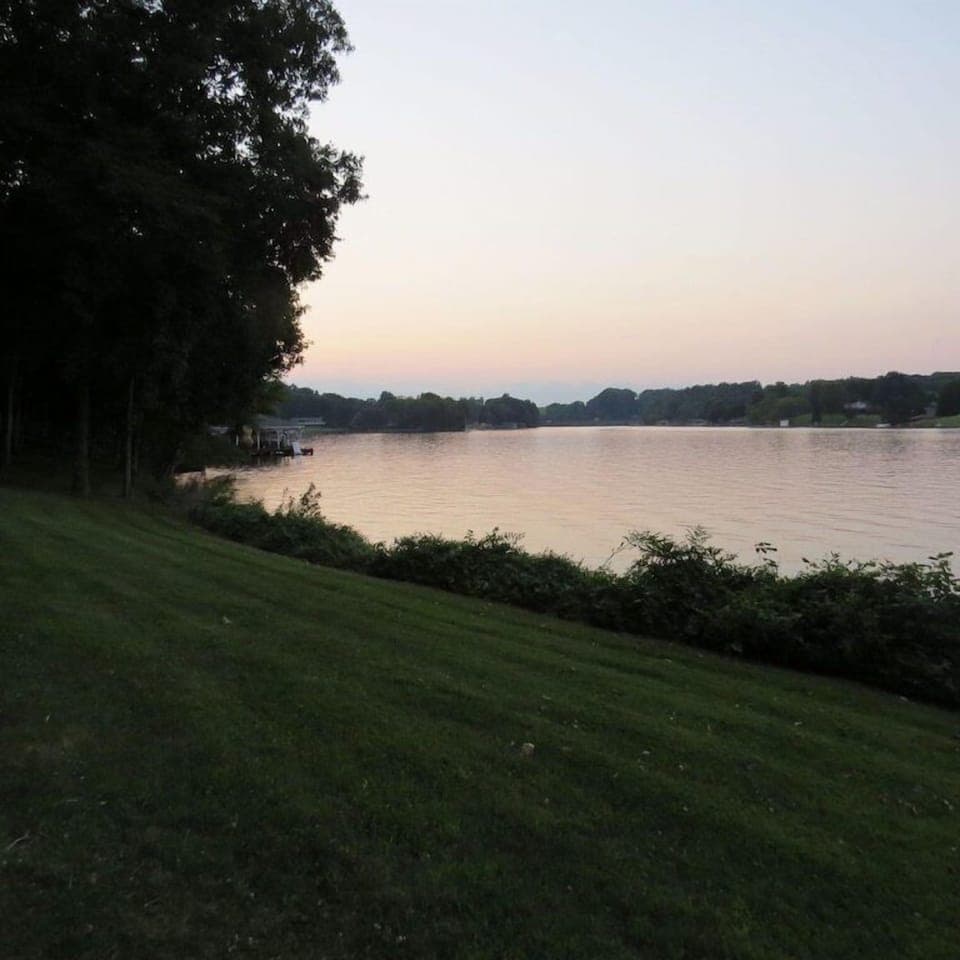 Gentle slope to the lake provides plenty of space for lawn games and cartwheels. 