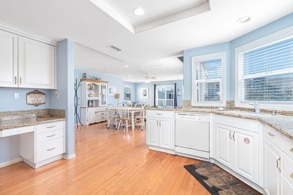 Kitchen includes built-in desk area and opens up to the main living area for fun, social meals.
                
