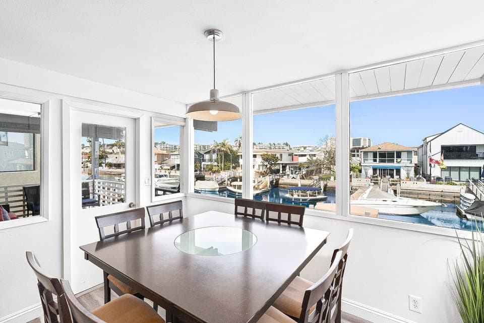 The bar height dining table w/ seating for 8 offers gorgeous bay views.
                