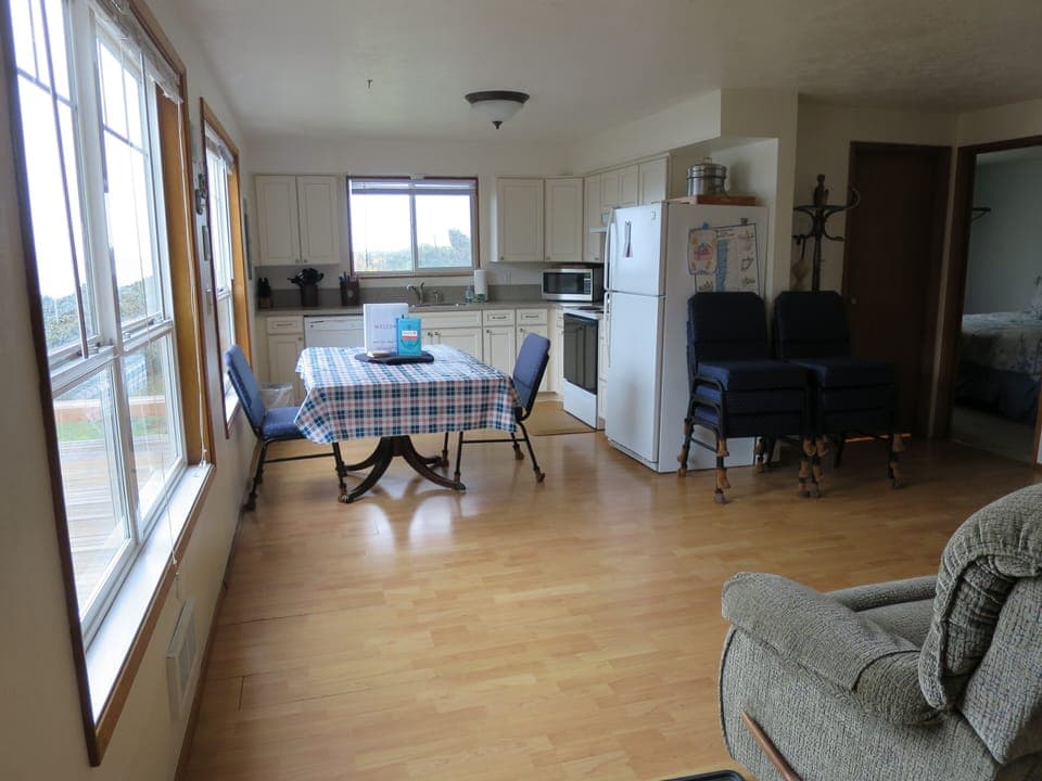 Main floor kitchen with microwave, pots/pans, oven, coffee pot, crockpot