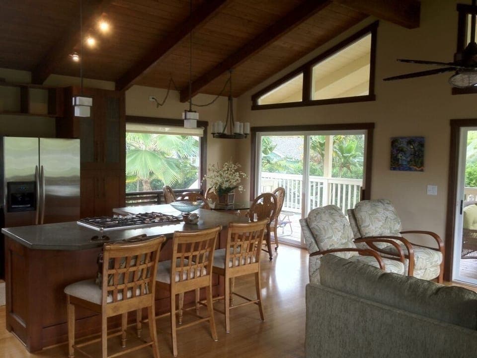 Great room with dining table and open bar.