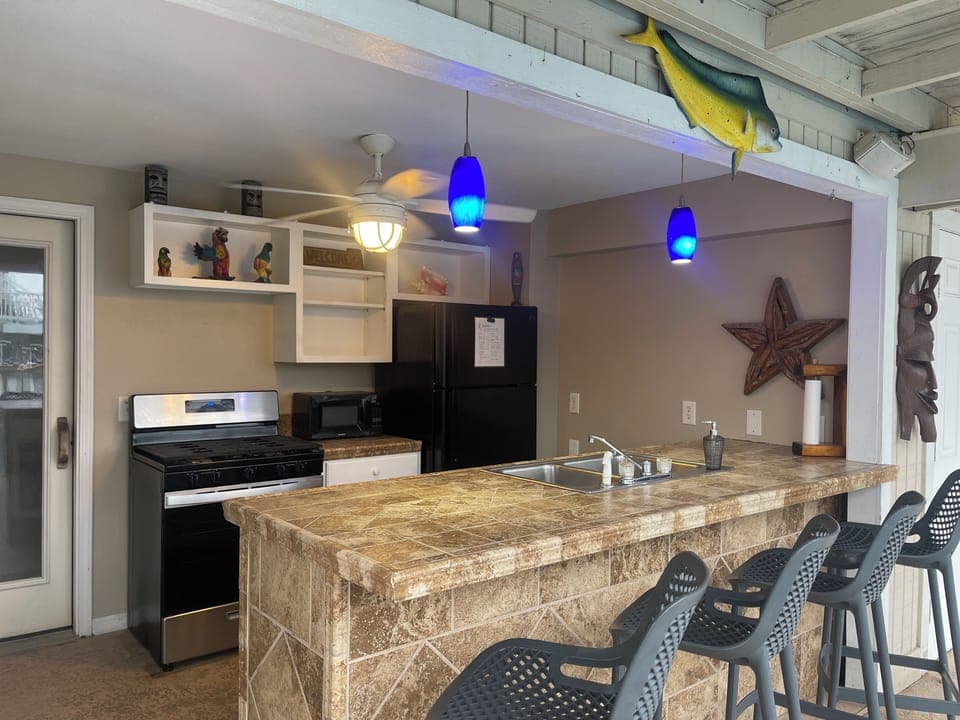 Outdoor kitchen with gas stove and full size refrigerator