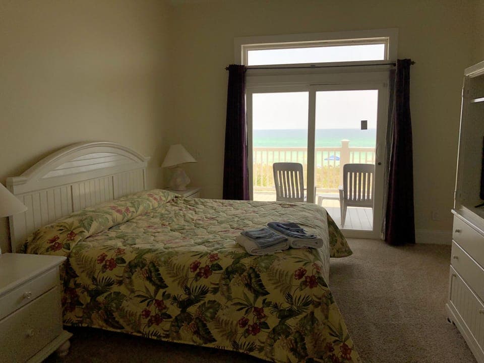 Master Bedroom with king size bed, tv, and view of the Gulf of Mexico.