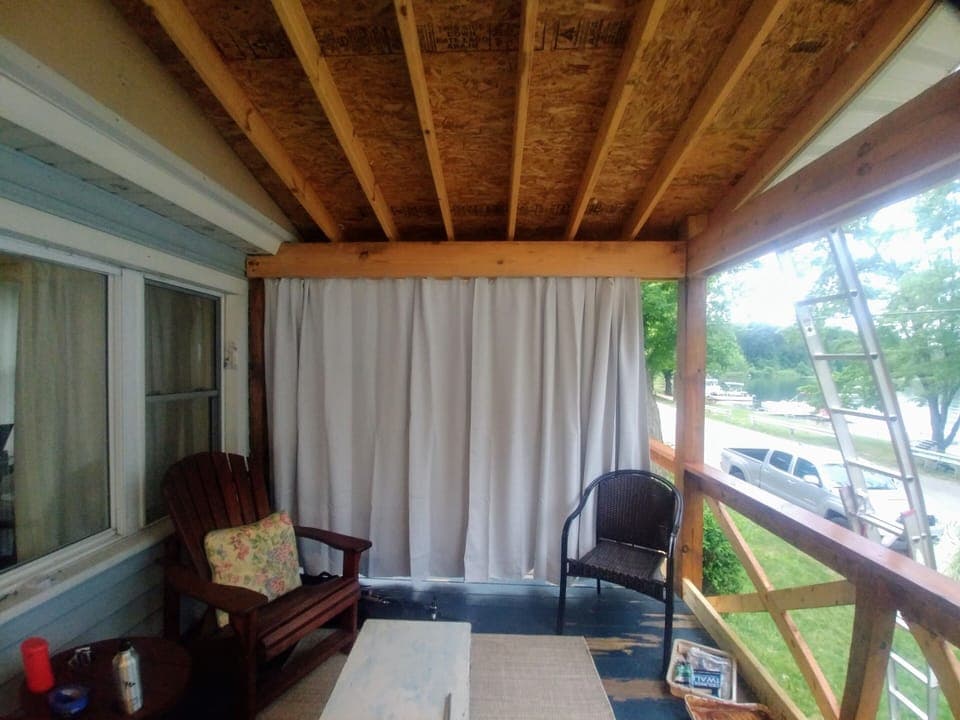 Seating on the deck includes wrought iron  table and wicker couch set.