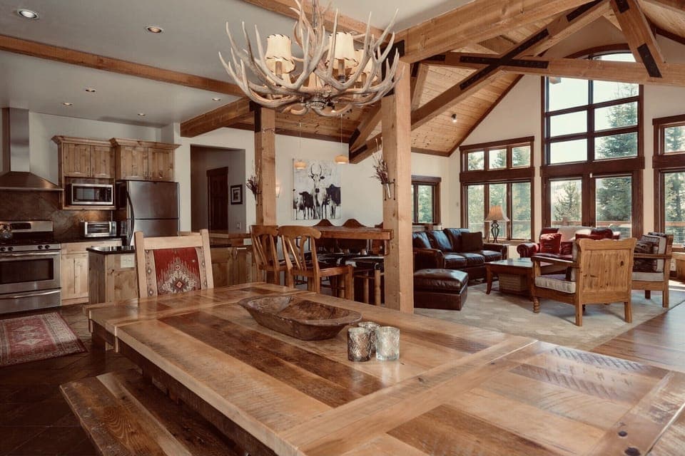 Large dining table with view of the mountain and backyard meadow 