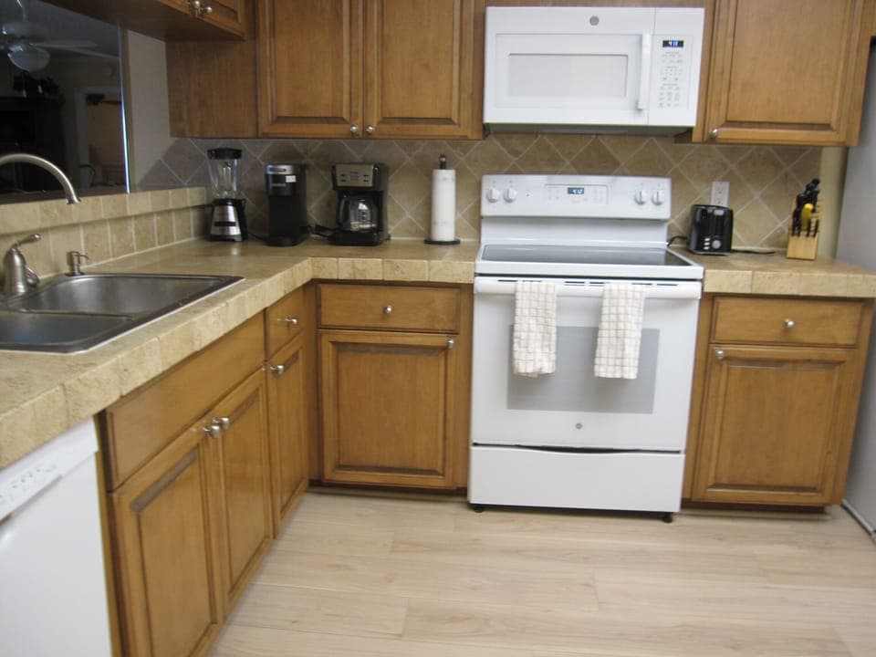 Kitchen with blender, toaster, Keurig pod and Mr. Coffee makers, knife block.