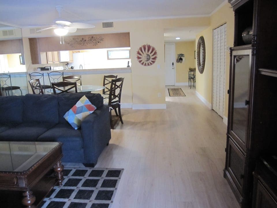 View of living and dining room towards front door showing new flooring (2025).