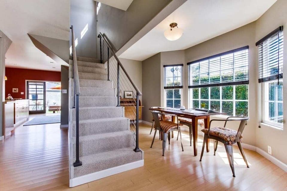 Dining seating for 4 next to the stairs.
