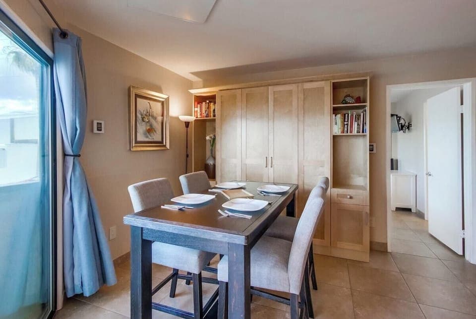 Dining room for 4 guests, armoire opens to an additional full size Murphy bed