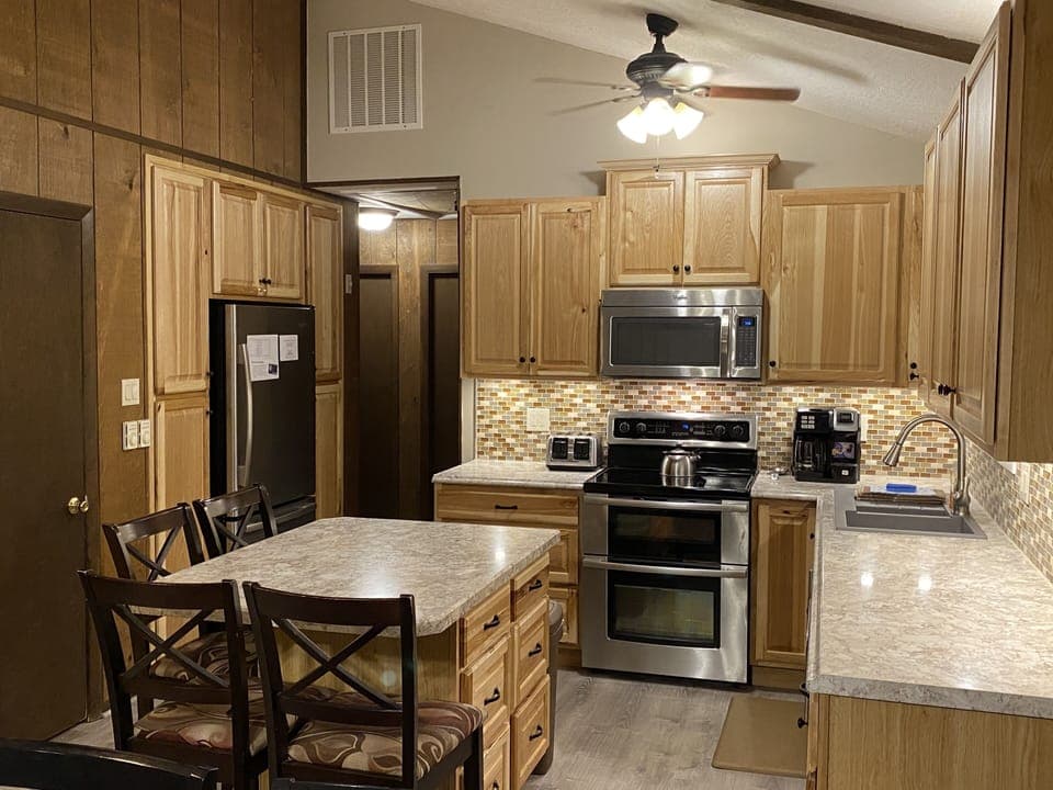 Fully stocked kitchen with double oven range, microwave, dishwasher & fridge