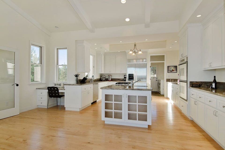 Chef's gourmet kitchen with double ovens, island, two sinks, and storage galore!