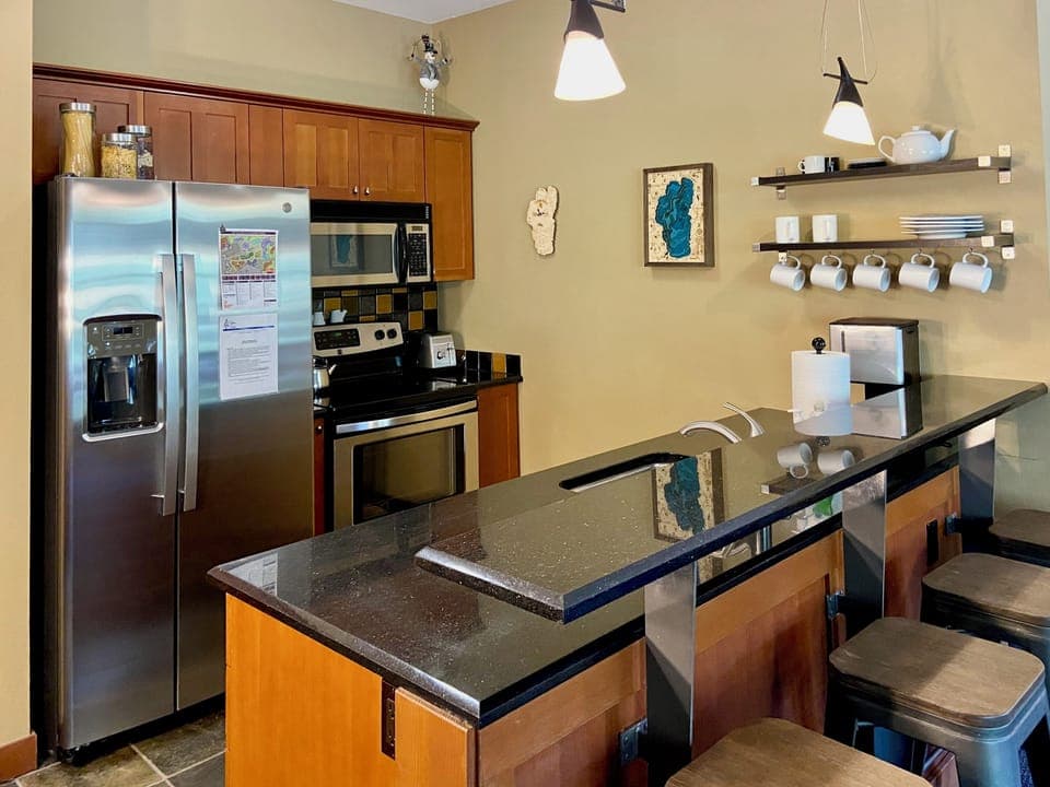 Full kitchen with modern appliances and stocked essentials