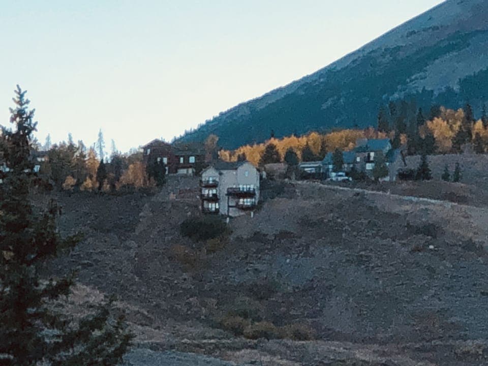 Light tan house on the hill