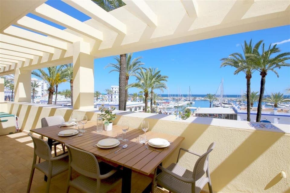 Large and sunny terrace facing south with outdoor dining area and sea views
