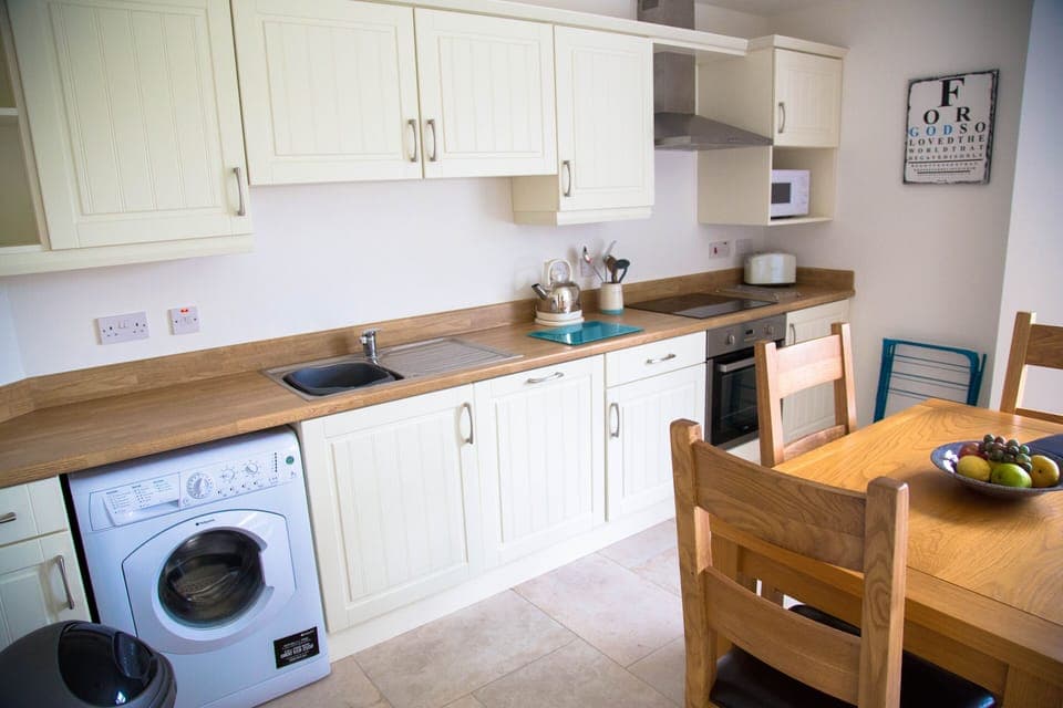 Well equipped kitchen has dishwasher, washing machine, microwave and cooker