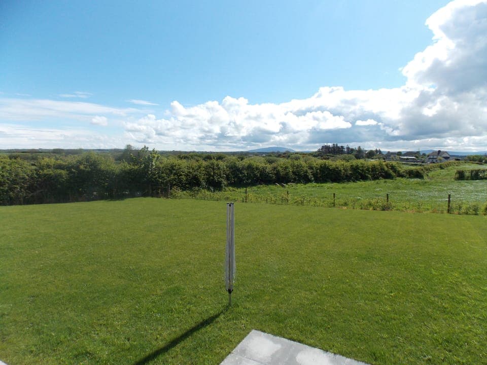 Garden laid to lawn with far reaching countryside views