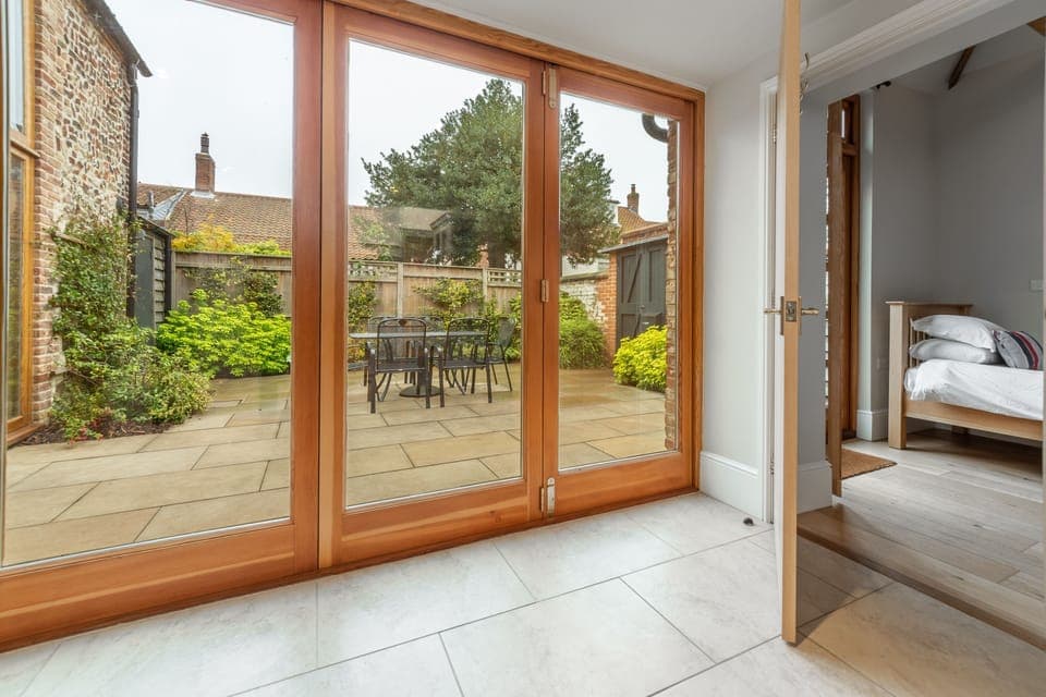 Ground floor: Bi-fold doors into courtyard, and bedroom two