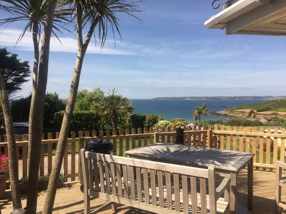 Enclosed decking area with outdoor tables and benches