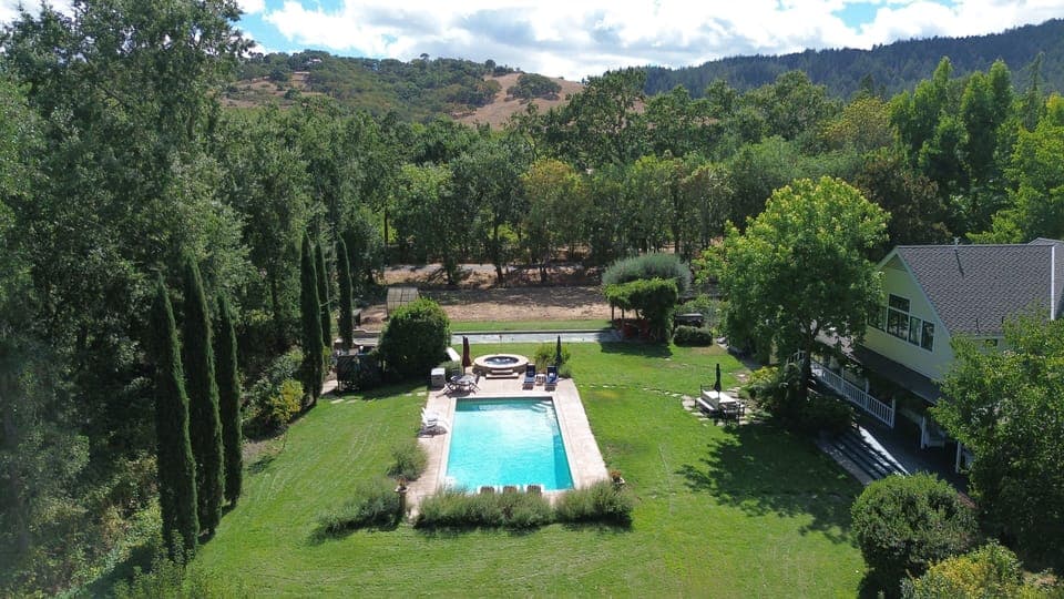 View southwest across rear of estate.  Pool, spa, and bocce court just past spa.