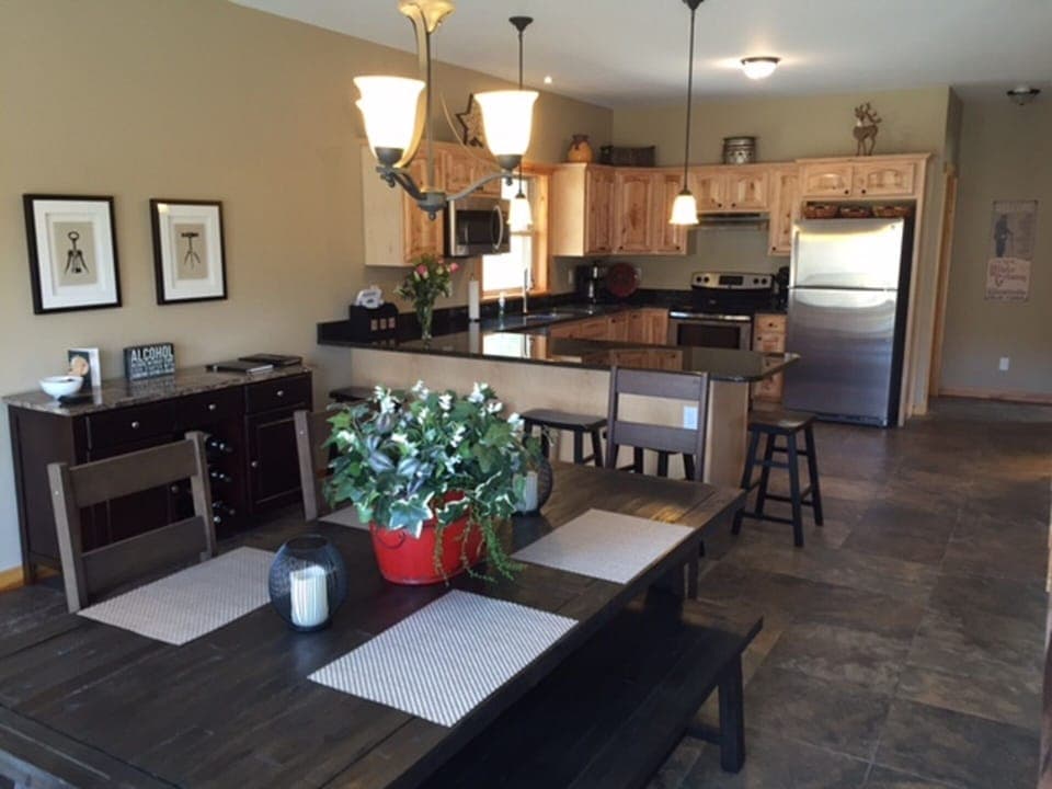 Dining room table, bar and kitchen from front sliding glass doors
