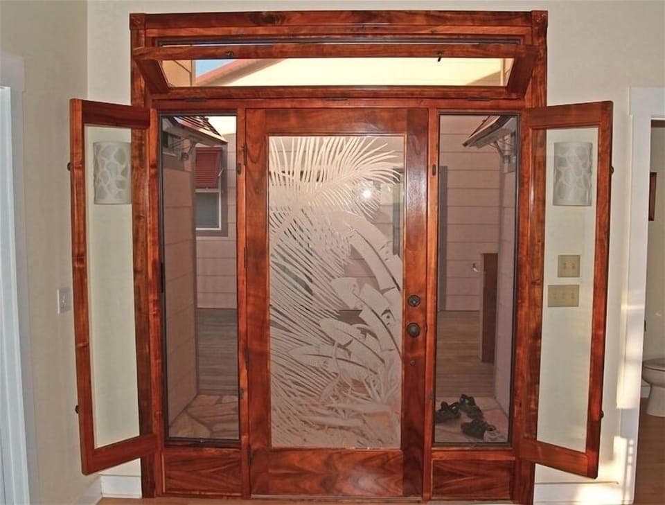 The beautiful entrance is made of rare Hawaiian Koa Wood