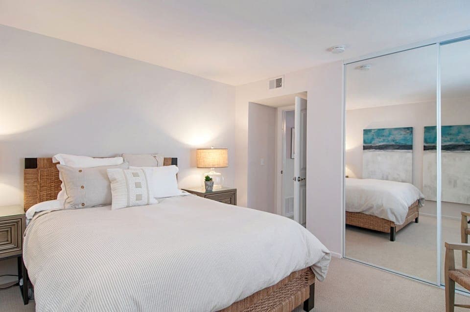 Second bedroom quietly positioned with large mirrored closet