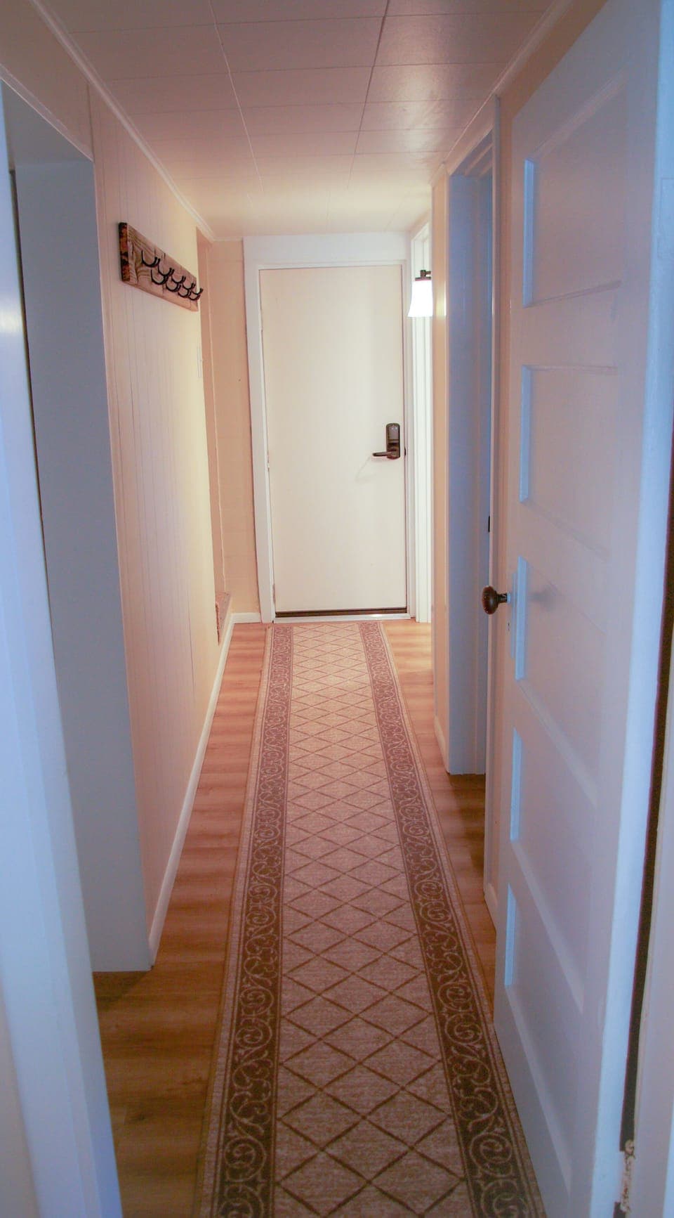The hallway leads all bedrooms and bathrooms. There is a door to separate all.