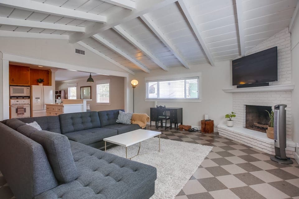 BIG couch, room for the whole family. The door in the picture leads to the fully fenced in back yard and outdoor eating area.

The fireplace is to not be utilized.