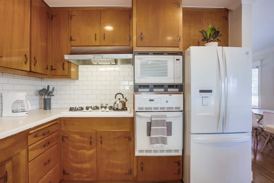 Kitchen fully stocked complete with dish washer, oven, microwave, coffee maker, blender, toaster, double door refrigerator and more.