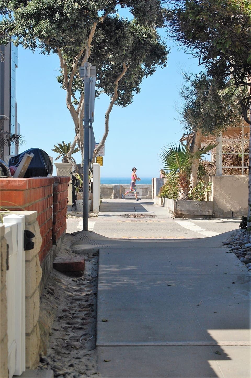 View from court walkway to the beach which is less than 50 steps away.