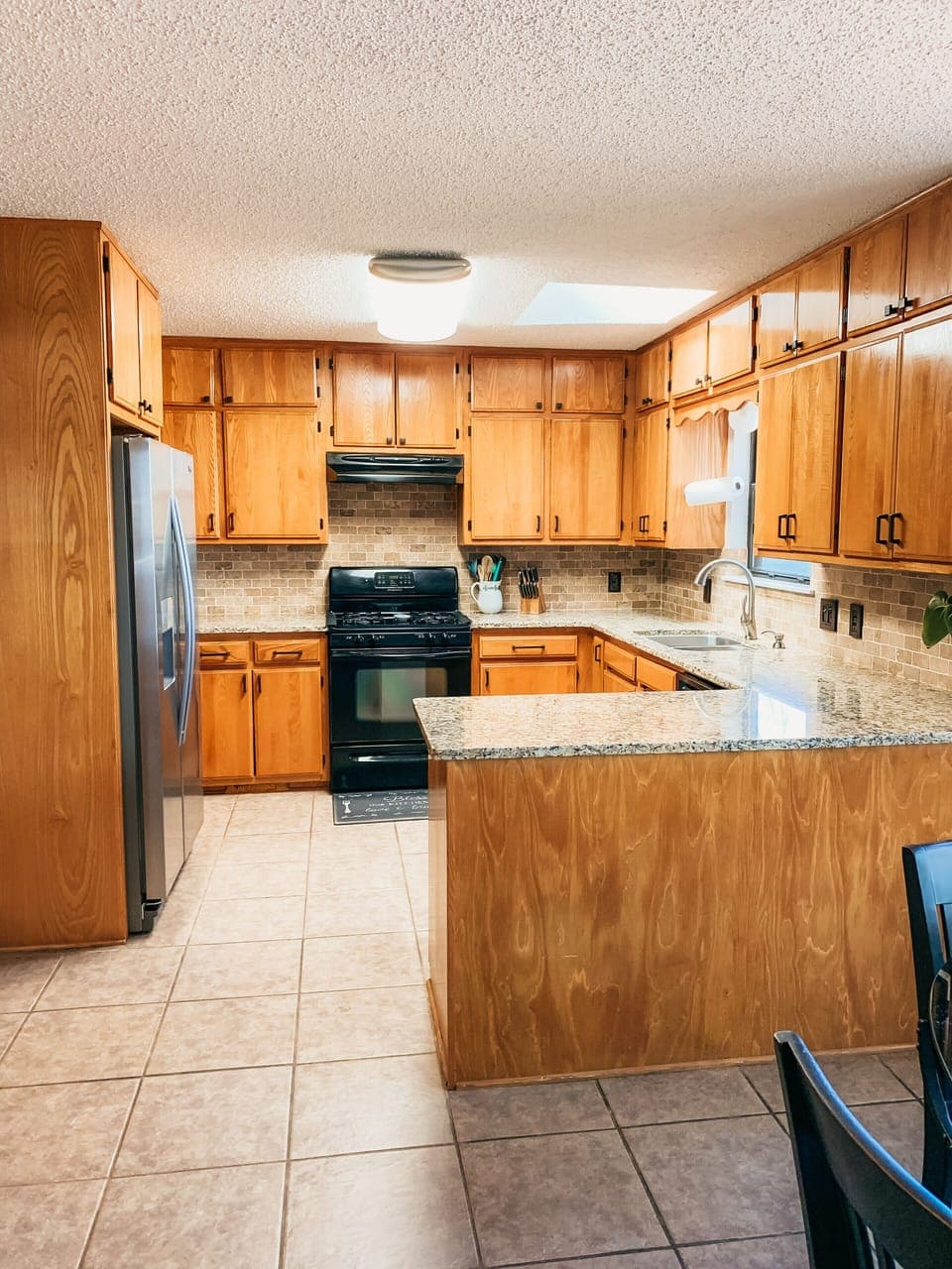 Kitchen with granite counters.   Gas stove 