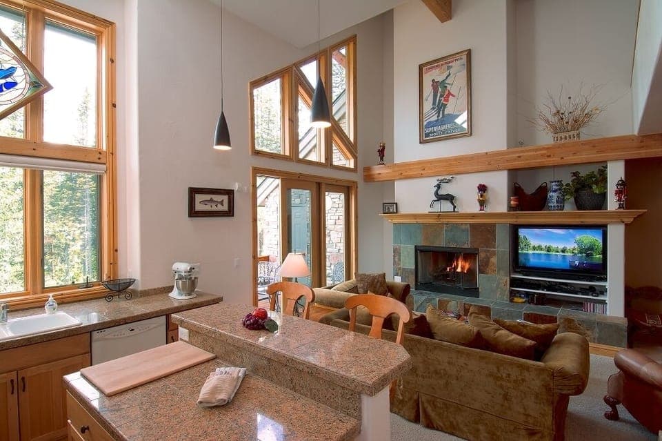 Work area in kitchen has seating, great outdoor and indoor views