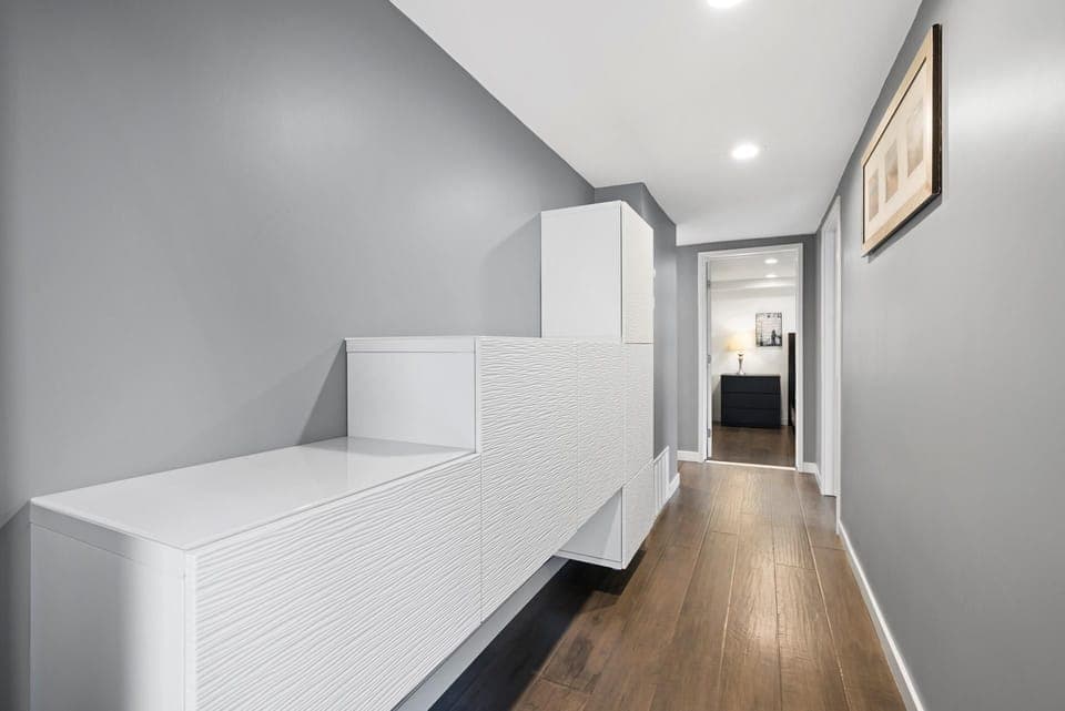 Ground floor main hallway leads between front entry door to rear garage access door. Primary bedroom, Bedroom #3 and main hallway bath also located here.
                