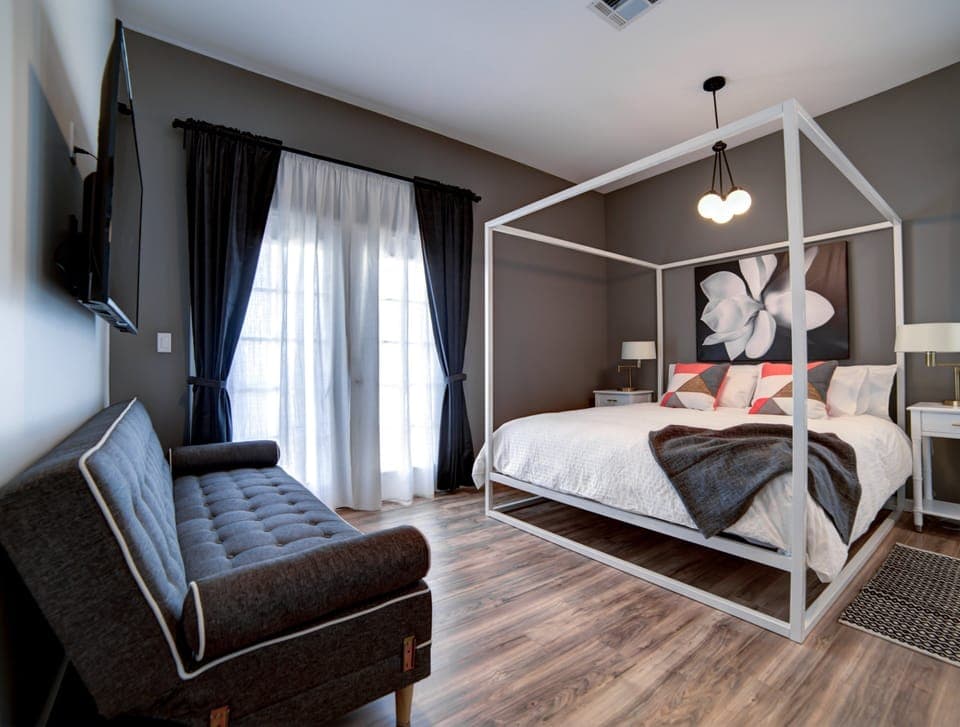 1 of our 6 adult bedrooms... en-suite King master with a futon and 55" smart TV