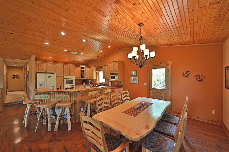 Large dining table with log accents and hand etched log stools.