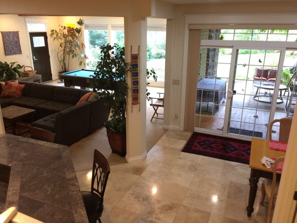Main living space has travertine stone tile, wall to wall carpet and cherry wood