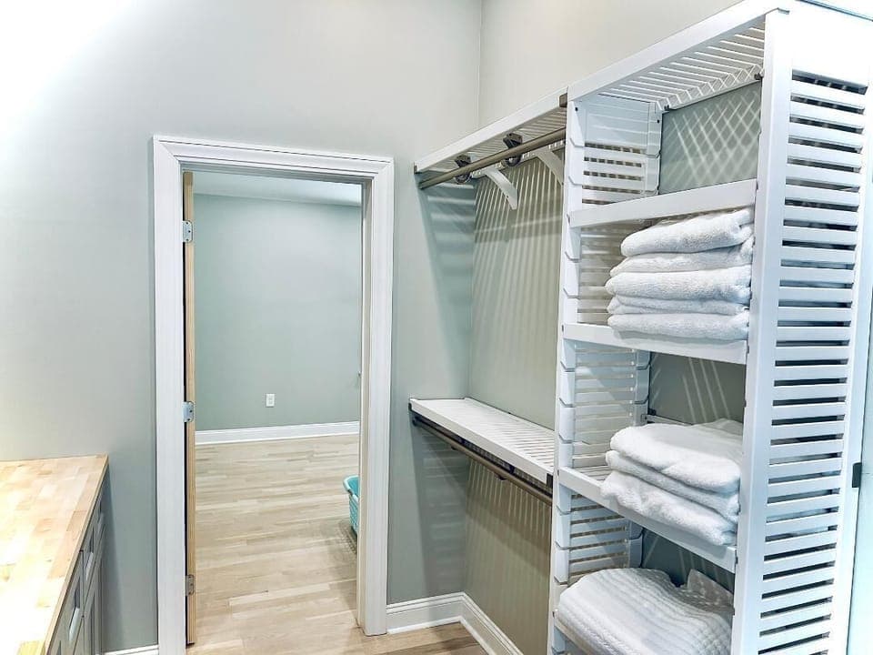 Laundry area includes plenty of hanging and storage areas